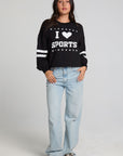 A full body front view of a woman wearing the Chaser I Love Sports Sweatshirt on a neutral background