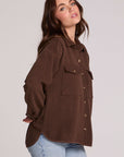 Side angle view of a woman wearing the Chaser Jaxxon Wood Brown Shacket on a neutral background with arms at back