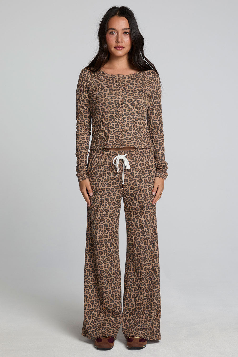 Full body front view of a woman wearing the Chaser  Jorgia Leopard Pant on a neutral background with matching top