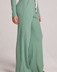 Side view of a woman wearing the Chaser  Jorgia Verdelle Pants on a neutral background with shirt