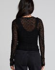 Back view of a woman wearing the Chaser Kevin Black Longsleeve on a neutral background with pants