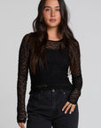 Front view of a woman wearing the Chaser Kevin Black Longsleeve on a neutral background with jeans