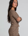 Side view of a woman wearing the Chaser  Klara Leopard Button Down Top on a neutral background with matching pants