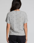 Back view of a woman wearing the Chaser Leonor Light Heather Grey Tee on a neutral background with black pants