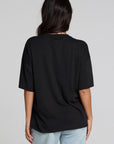 Back view of a woman wearing the Chaser Let's Get Spooky Tee on a neutral background with jeans