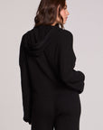 Back view of a woman wearing the Chaser Lizbeth Black Hoodie Jacket and pants on a neutral background