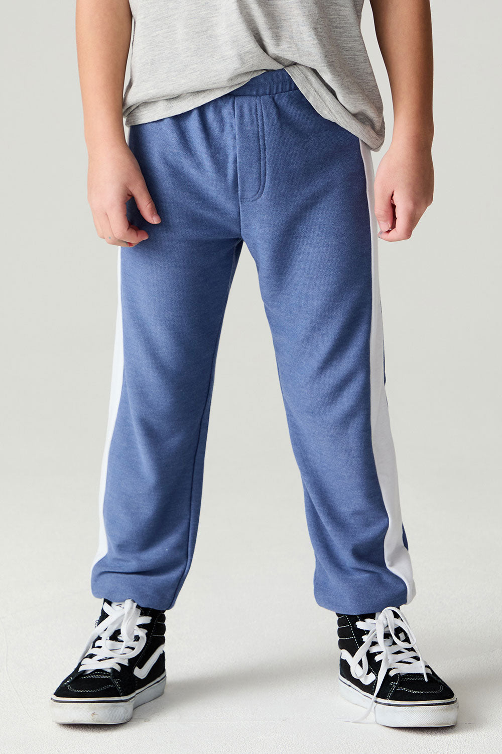 Front view of a boy wearing the Chaser Lounge Pants Boys Shamu Jogger on a neutral background with tee shirt
