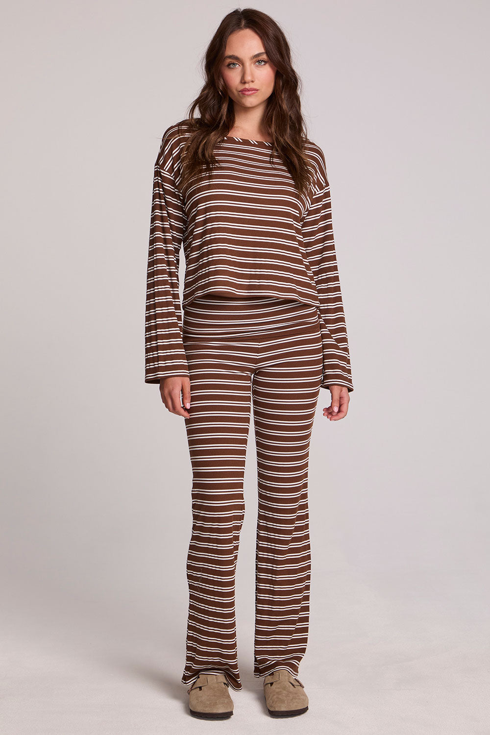 A full body front view of a woman wearing the Chaser Lunnah Nutty Brown Top and matching pants on a neutral background 