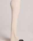 Side view of a woman wearing the Chaser  Mariya Amtique White Pants on a neutral background with shoes