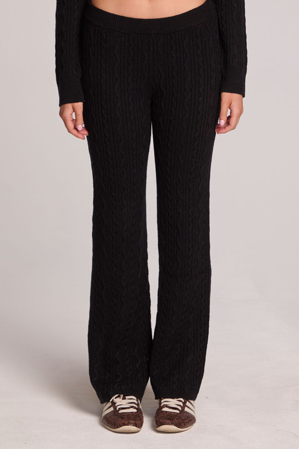 Front view of a woman wearing the Chaser  Mariya Black Pants on a neutral background