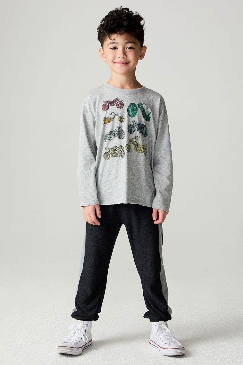 Front view of a boy wearing the Chaser Moto Pants Boys Jogger and matching tee on a neutral background