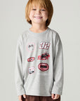Front view of a boy wearing the Chaser Moto Patches Boys Tee on a neutral background with arms lowered at sides