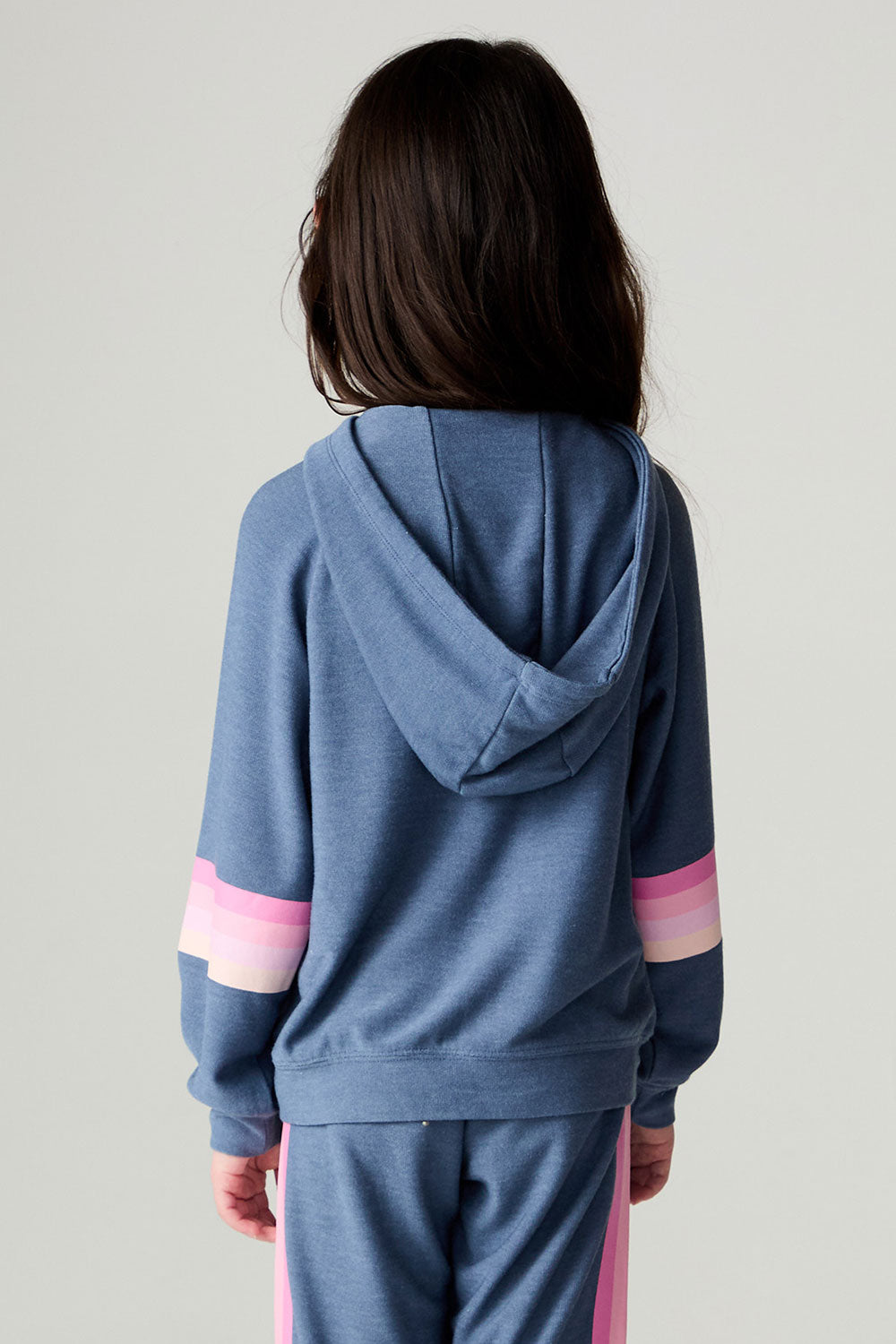 Back view of a girl wearing the Chaser Multi Stripes Girls Hoodie on a neutral background