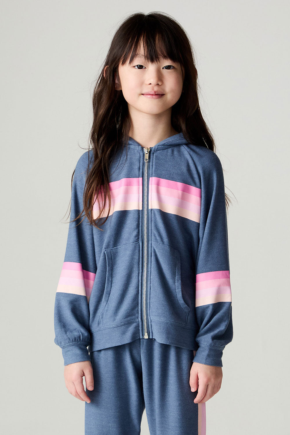 Full body front view of a girl wearing the Chaser Multi Stripes Girls Hoodie on a neutral background with hands at sides