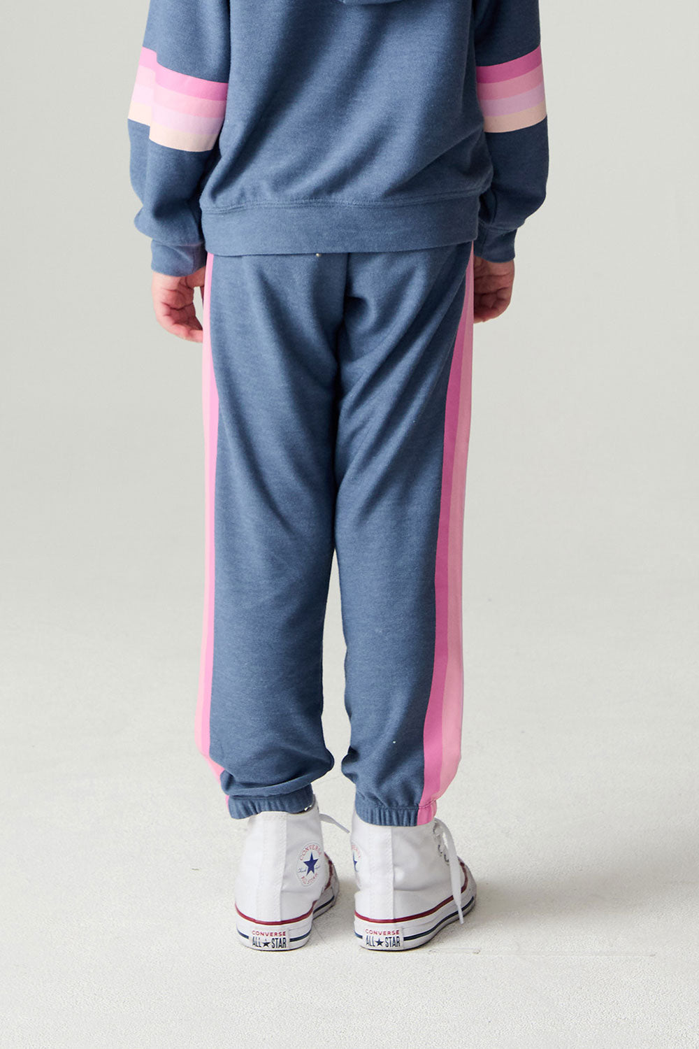 Back view of a girl wearing the Chaser Multi Stripes Girls Jogger on a neutral background