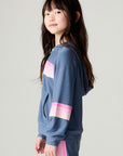 Side view of a girl wearing the Chaser Multi Stripes Girls Hoodie on a neutral background with arms at sides