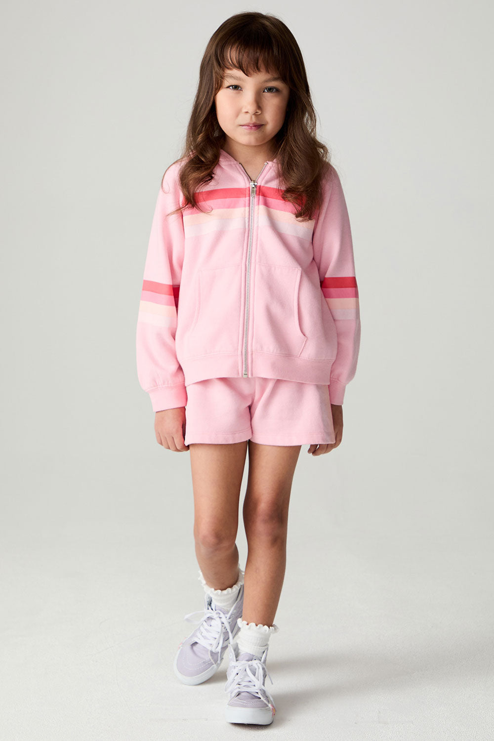 A full body front view of a girl wearing the Chaser Multi Stripes Girls Zip Up on a neutral background