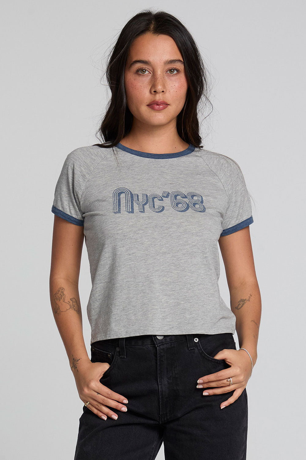Front view of a woman wearing the Chaser NYC 68 Ringer Graphic Tee on a neutral background