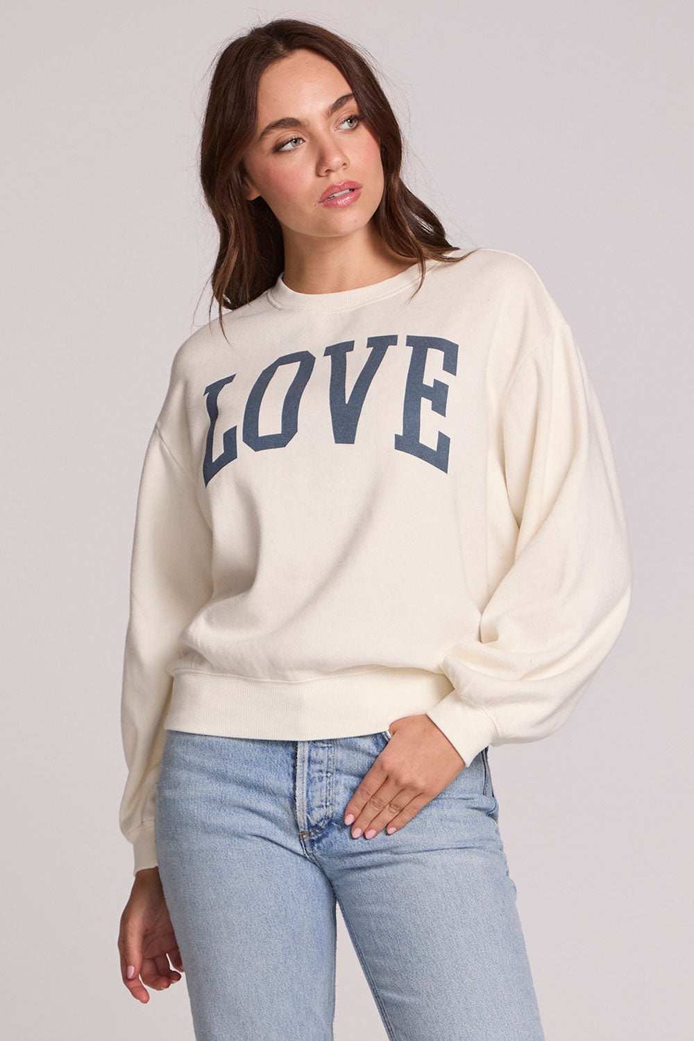 Front view of a woman wearing the Chaser Navy Love Pullover Sweater on a neutral background 