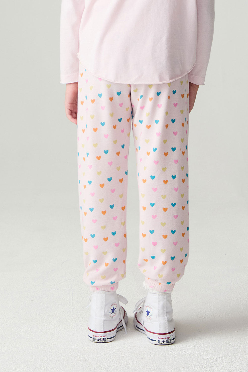 Back view of a girl wearing the Chaser Party Hearts Girls Jogger on a neutral background