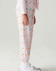 Side view of a girl wearing the Chaser Party Hearts Girls Jogger on a neutral background with hands at sides