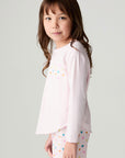 Side view of a girl wearing the Chaser Party Hearts Girls Tee on a neutral background with shirt