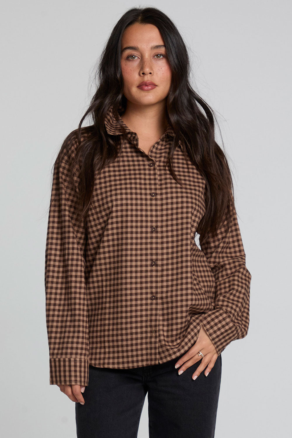 Front view of a woman wearing the Chaser Pine button down on a neutral background