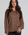 Front view of a woman wearing the Chaser Pine button down on a neutral background