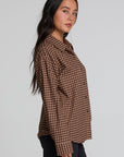 Side view of a woman wearing the Chaser Pine button down on a neutral background with arms at her sides