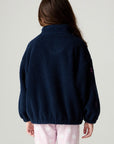 Back view of a girl wearing the Chaser Power Love Girls Jacket on a neutral background with arms down