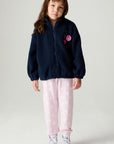 A full body front view of a girl wearing the Chaser Power Love Girls Jacket on a neutral background with pants