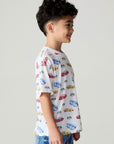 Side view of a boy wearing the Chaser Race Day Boys Tee on a neutral background with bluejeans