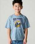 Front view of a boy wearing the Chaser Racers Boys Tee on a neutral background with jeans and arms at sides and jeans