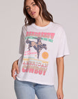 Front view of a woman wearing the Chaser Rodeo Show Tee on a neutral background with pants and hand on hip