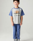 A full body front view of a boy wearing the Chaser Rookie Boys Tee on a neutral background with arms at sides
