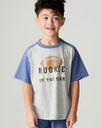 Front view of a boy wearing the Chaser Rookie Boys Tee on a neutral background with arms at sides and matching blue pants