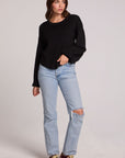 A full body front view of a woman wearing the Chaser Ruthy Black Fullsleeve Top on a neutral background