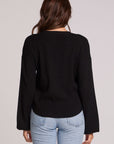 Back view of a woman wearing the Chaser Ruthy Black Fullsleeve Top on a neutral background with jeans