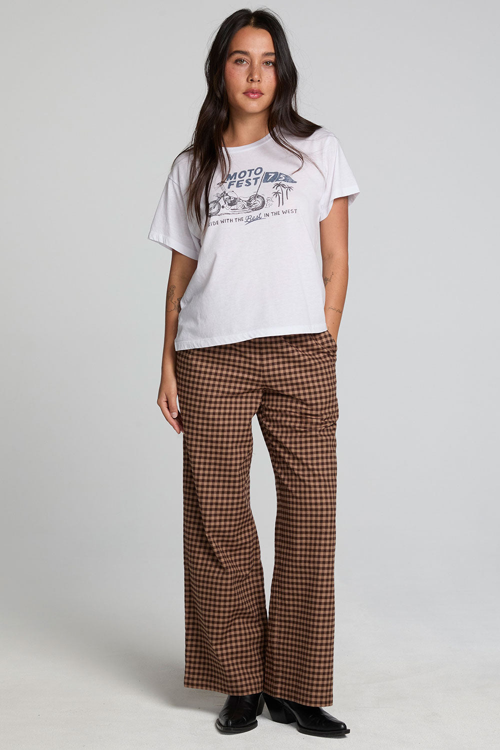 A full body front view of a woman wearing the Chaser Seren Choco Check Pants on a neutral background