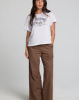 A full body front view of a woman wearing the Chaser Seren Choco Check Pants on a neutral background