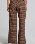 Back view of a woman wearing the Chaser Seren Choco Check Pants on a neutral background with hands at sides