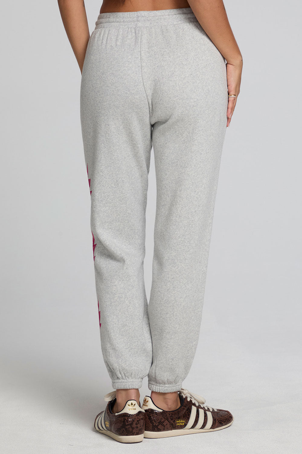 Back view of a woman wearing the Chaser  Shocking Bolt Pants on a neutral background