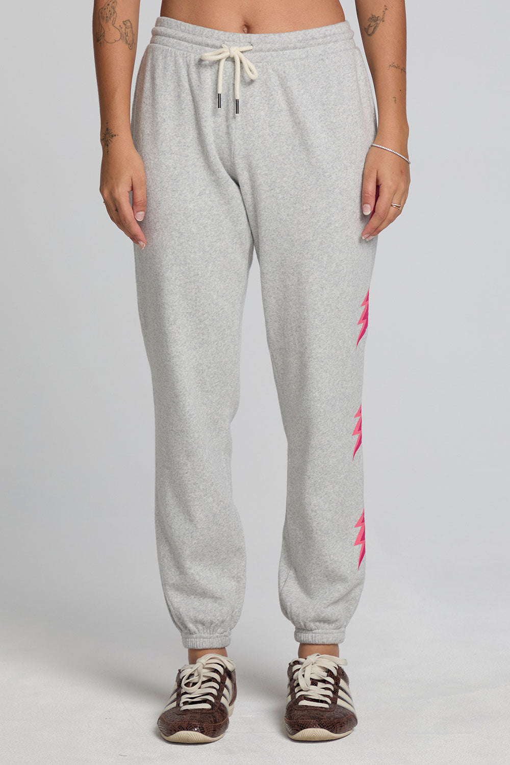 Front view of a woman wearing the Chaser  Shocking Bolt Pants on a neutral background with arms lowered at sides