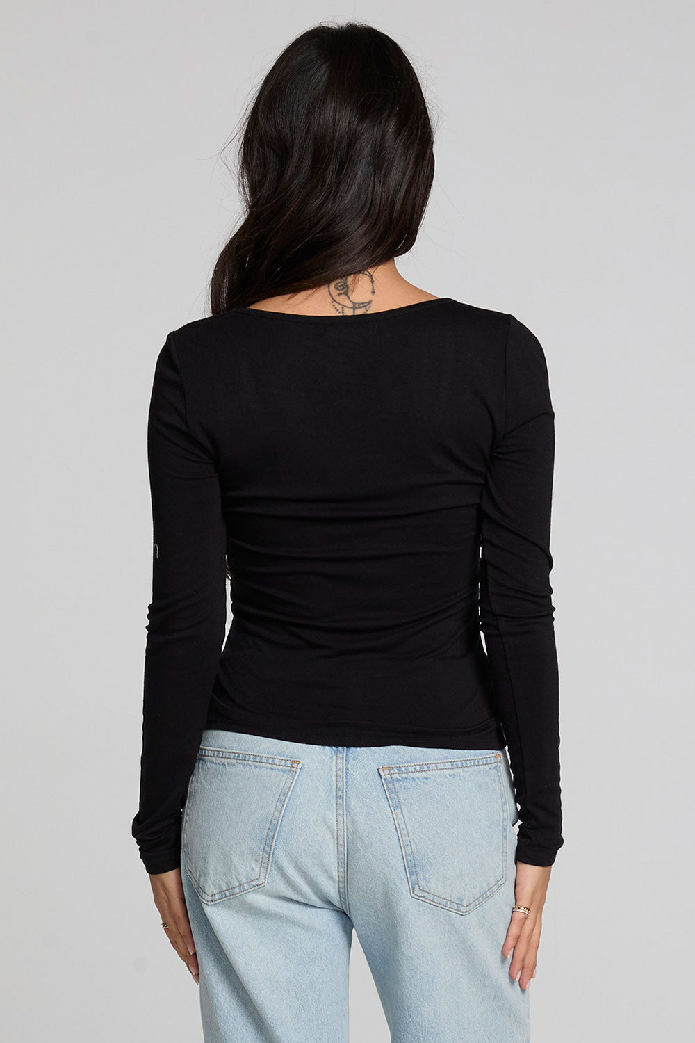 Back view of a woman wearing the Chaser Silva Black Fullsleeve Top on a neutral background