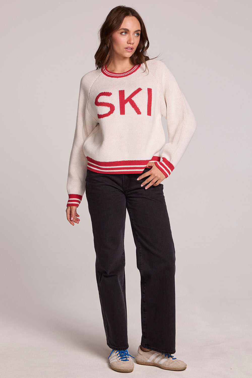 A full body front view of a woman wearing the Chaser Ski Longsleeve on a neutral background