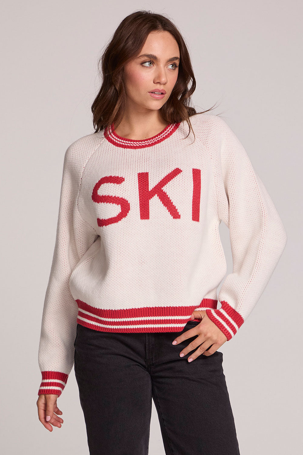 Front view of a woman wearing the Chaser Ski Longsleeve on a neutral background with black pants