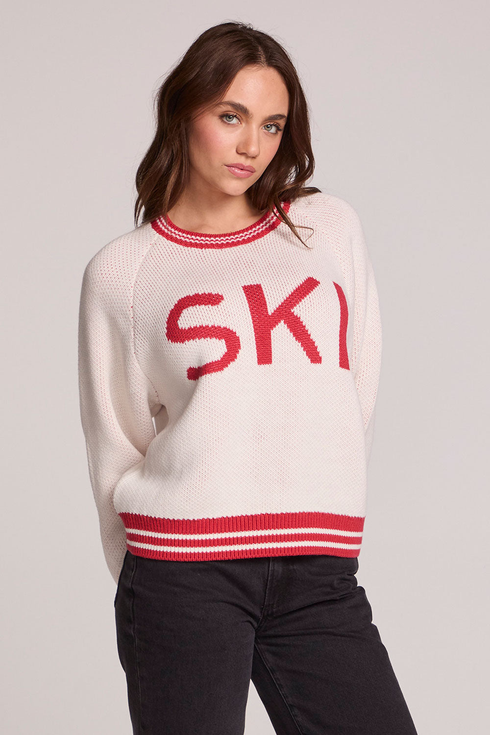 Front view of a woman wearing the Chaser Ski Longsleeve on a neutral background with arms behind back