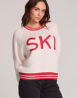 Front view of a woman wearing the Chaser Ski Longsleeve on a neutral background with arms behind back