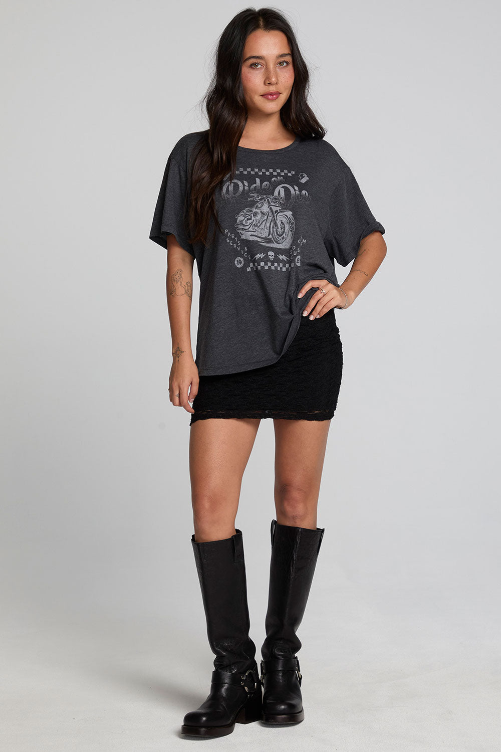 A full body front view of a woman wearing the Chaser Socal Motorcycles Tee on a neutral background