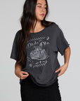 A full body front view of a woman wearing the Chaser Socal Motorcycles Tee on a neutral background with black skirt